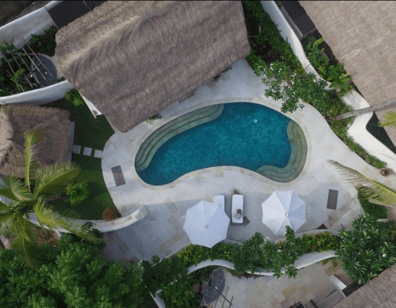Aerial view of Deluxe Private Pool Villa at Pondok Santi Estate, Gili Trawangan, showcasing villa, private pool, and garden from above.