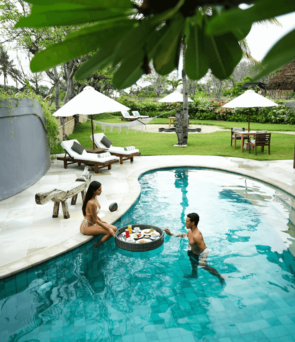 Couple enjoying floating breakfast in private pool at Deluxe Private Pool Villa, Pondok Santi Estate, Gili Trawangan.