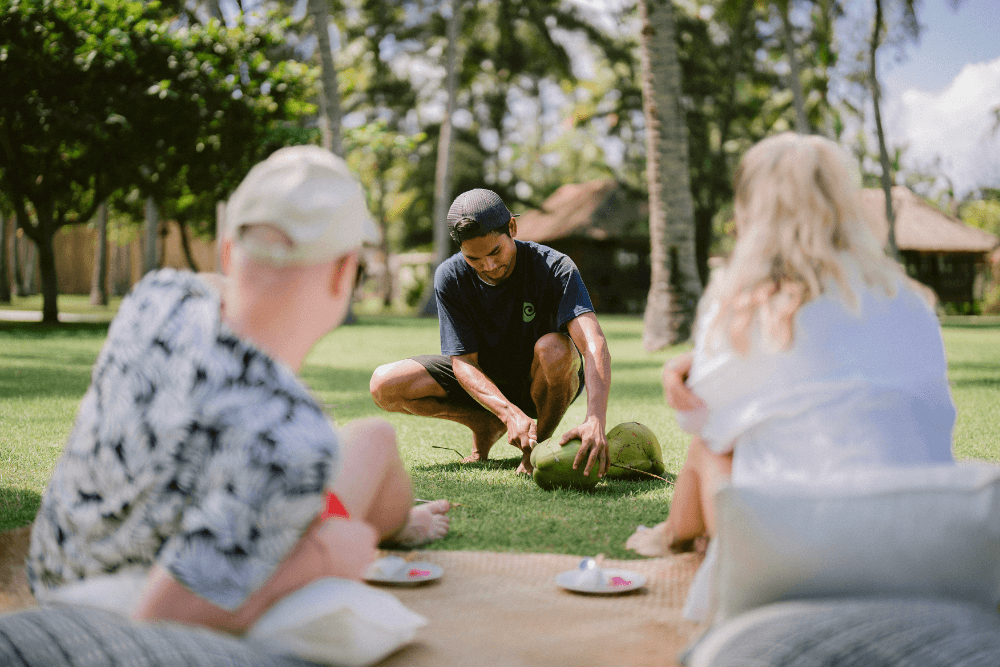 Guests enjoying a demonstration of coconut preparation during Santi Coco activity at Pondok Santi Estate.