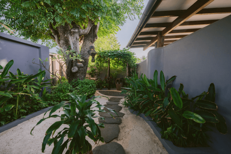 Spacious and beautiful outdoor shower at Pondok Santi Estate, Gili Trawangan, surrounded by tropical greenery.