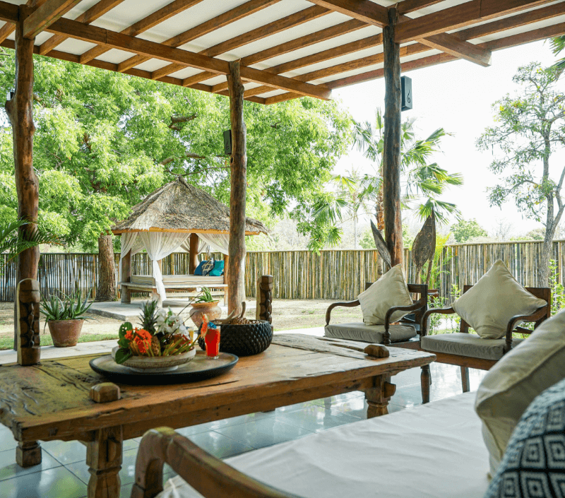 Open living room in 2-bedroom family villa at Pondok Santi Estate, Gili Trawangan, with ample seating and lush garden views.
