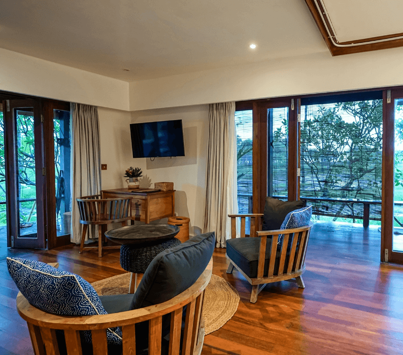 Comfortable seating area in 2 Bedroom Ocean View Family Villa at Pondok Santi Estate, Gili Trawangan, with chairs and terrace overlooking the estate.