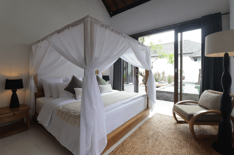 King-size bed in the 2-bedroom pool villa at Pondok Santi Estate, Gili Trawangan, offering luxurious comfort and a serene atmosphere.