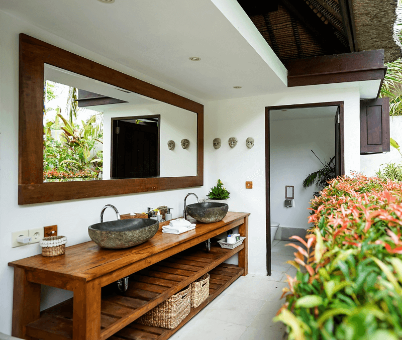 Outdoor bathroom of the Ocean Private Pool Villa at Pondok Santi Estate, Gili Trawangan, featuring twin sinks and lush plants.