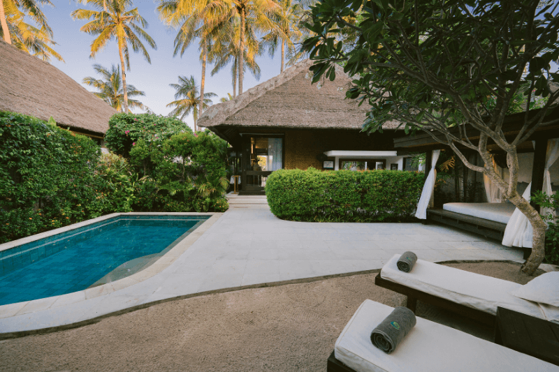 Private pool in the garden of the Ocean Private Pool Villa at Pondok Santi Estate, Gili Trawangan, with sun loungers and villa in the background.