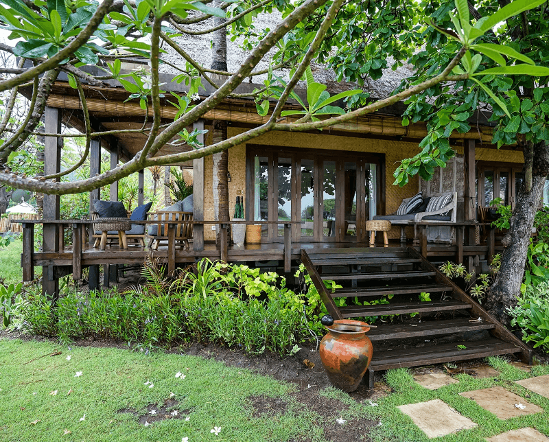 Exterior view of 2 Bedroom Ocean View Family Villa at Pondok Santi Estate, Gili Trawangan, featuring stairs leading to terrace around the villa.