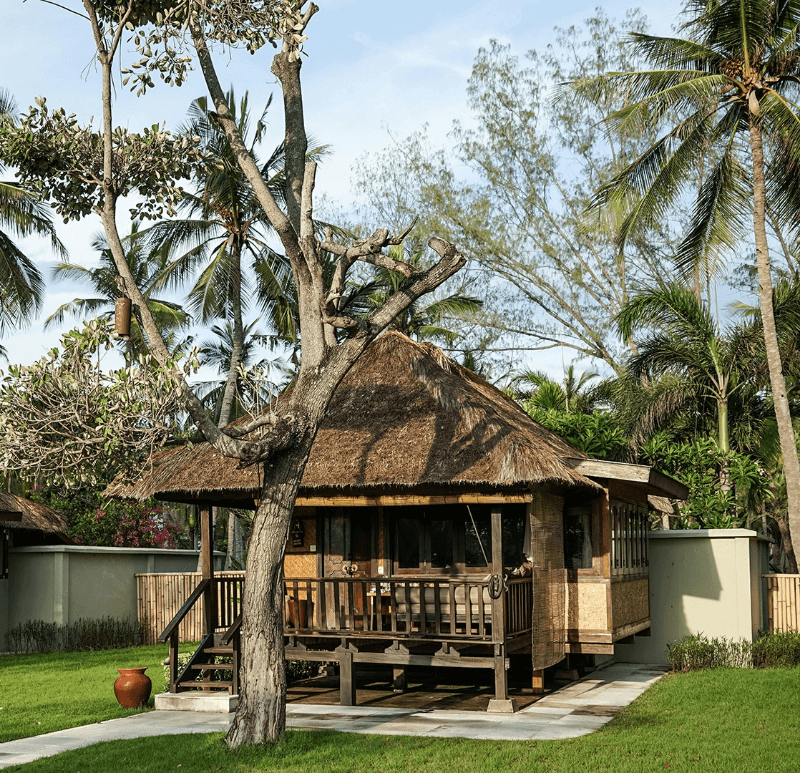 Beachside Bungalow at Pondok Santi Estate, Gili Trawangan, nestled among trees, offering a serene and natural setting.