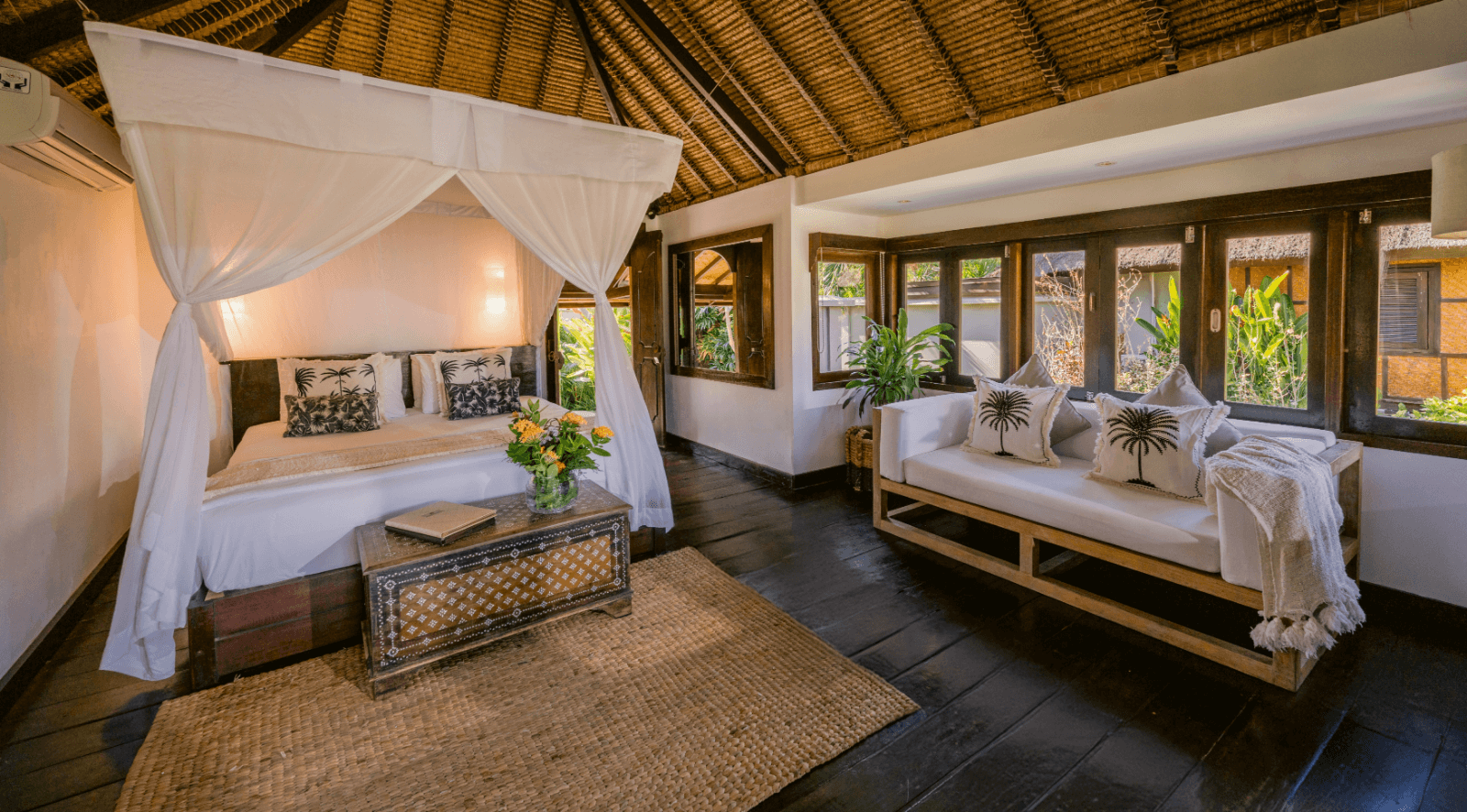 Palm view bungalow showcasing a serene bed and elegant furnishings.