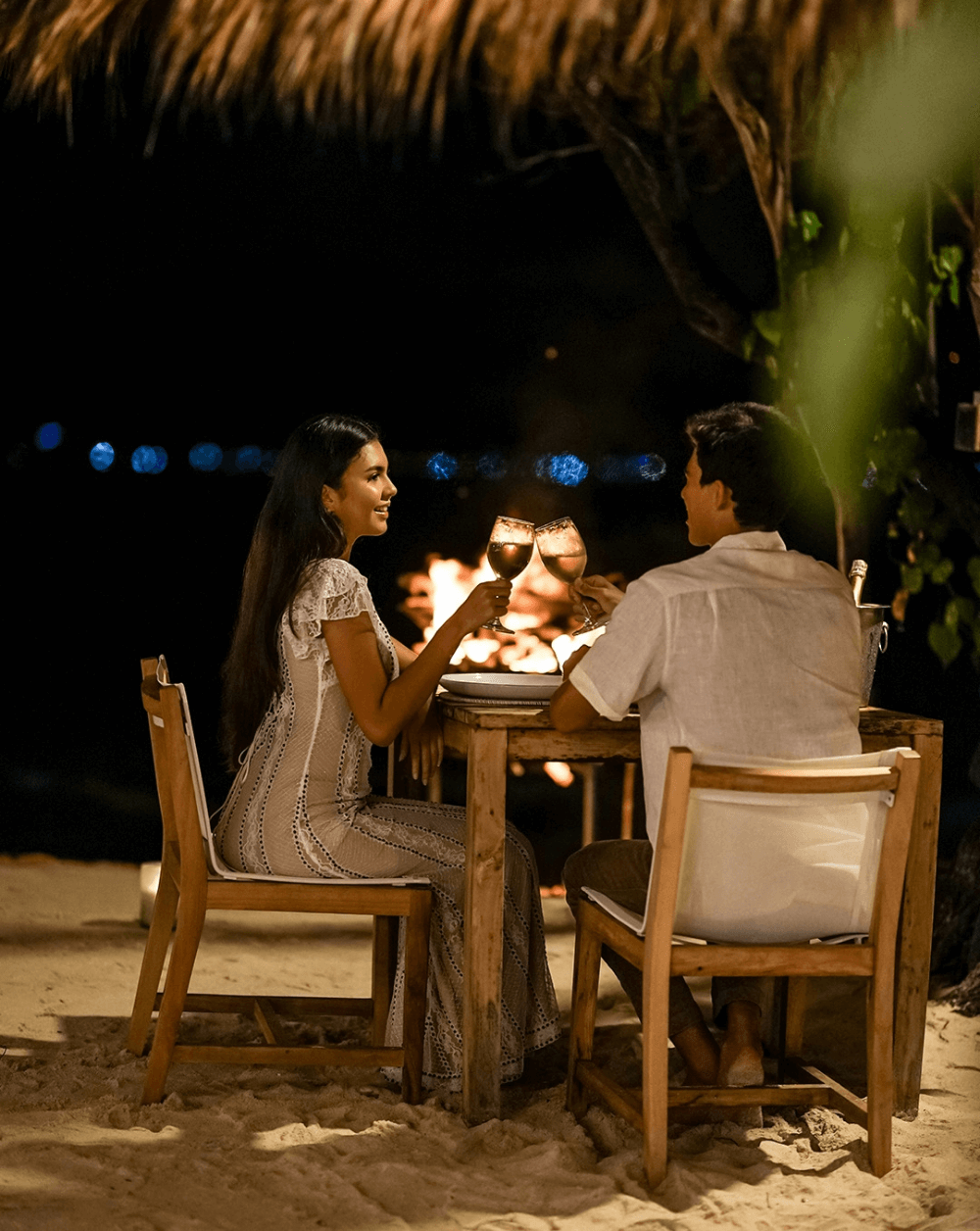 Couple toasting with wine at romantic dinner, Pondok Santi Estate, Gili Trawangan.