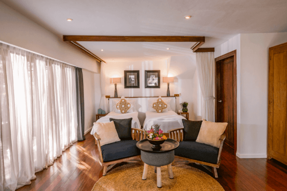 Room with twin beds and seating in 2 Bedroom Ocean View Family Villa at Pondok Santi Estate, Gili Trawangan.