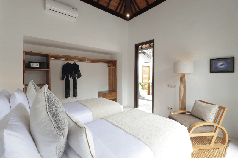 Twin beds in the 2-bedroom pool villa at Pondok Santi Estate, Gili Trawangan, offering a comfortable and stylish setting for guests.